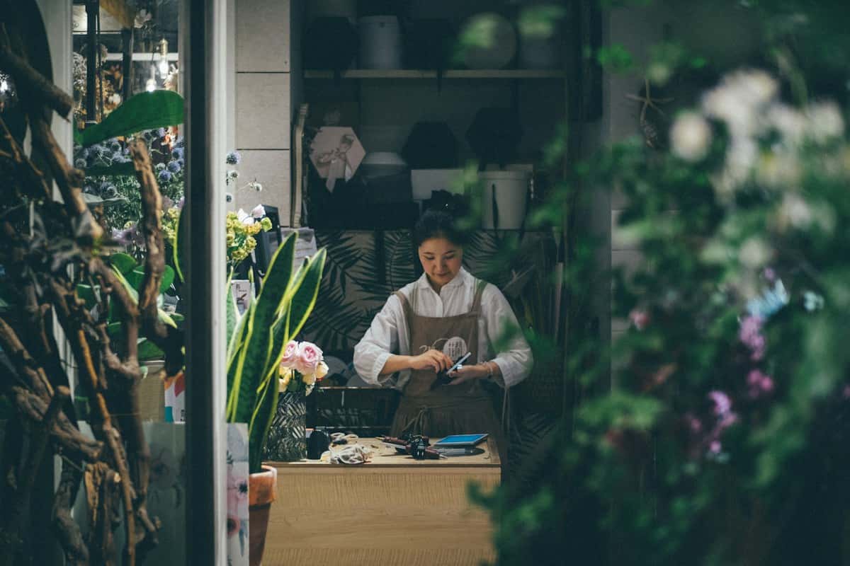 A florist working at her shop counter